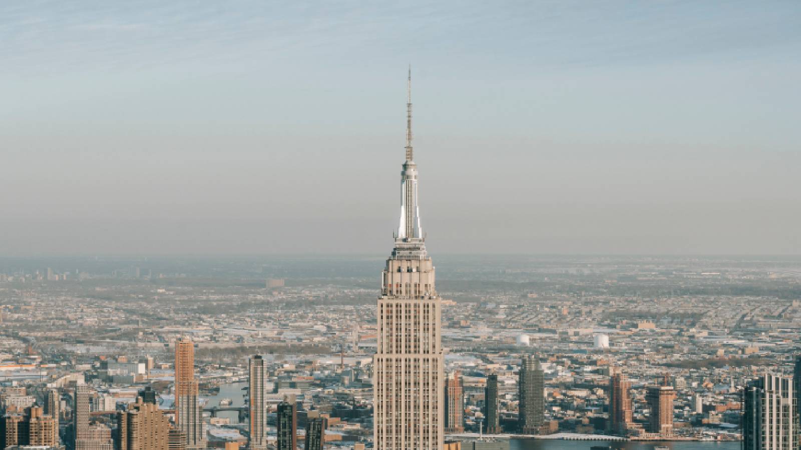 Two people hang banner about 'the power of love' on Empire State Building antenna