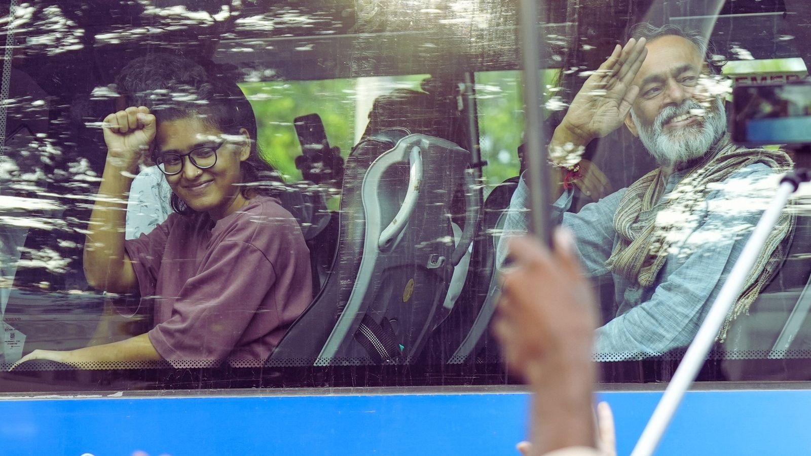 AISA leader Neha Bora, activist Yogendra Yadav greet the supporters from a bus in New Delhi on October 12, 2026. Photo: PTI