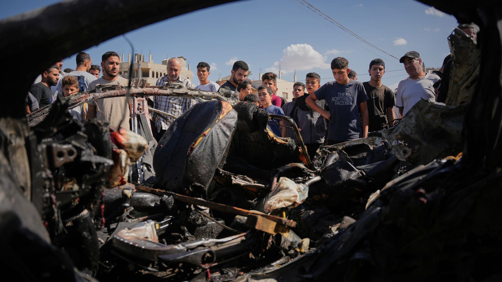 Palestinians inspect the wreckage of a vehicle destroyed in an Israeli airstrike in the Maghazi refugee camp in the central Gaza Strip on October 29, 2026. Photo: AP/PTI