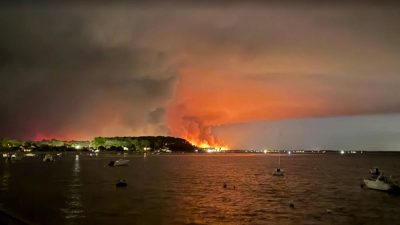 Over 200,000 people flee raging wildfires in France and Spain; some escaping by boat