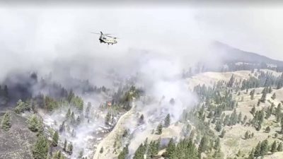 Wildfires rage across US West as helicopter crashes in Utah, worker dies in Oregon